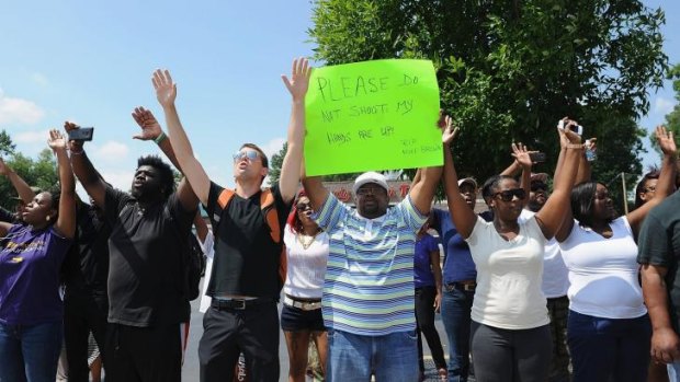 'Don't shoot': protesters confront police in St Louis after Michael Brown was shot.