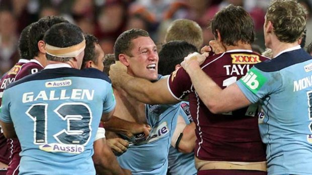Mate v hate . . . NSW forward Luke O'Donnell trades blows with David Taylor during the spiteful encounter at Suncorp Stadium.