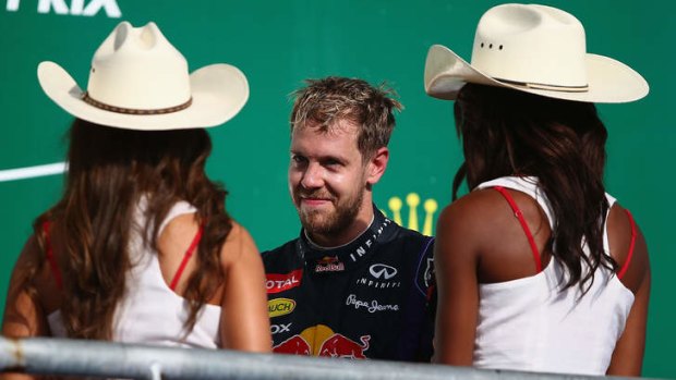 Riding high: Sebastian Vettel celebrates on the podium after winning the US Grand Prix.