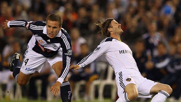 Impetuous youth: Victory's Petar Franjic makes contact with Galaxy's David Beckham and gives away a penalty last night.
