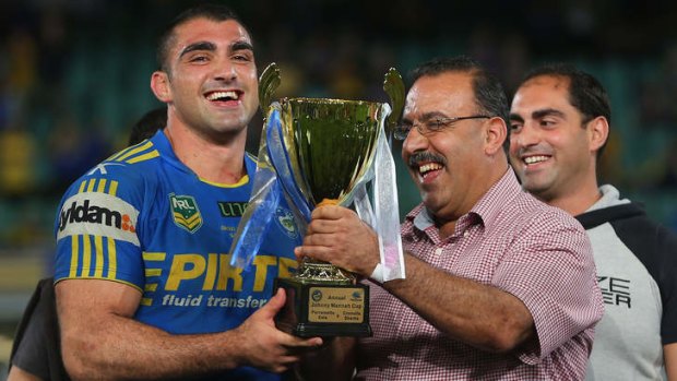 Family matters: Tim Mannah and his father, Fred, with the Johnny Mannah Cup in 2013