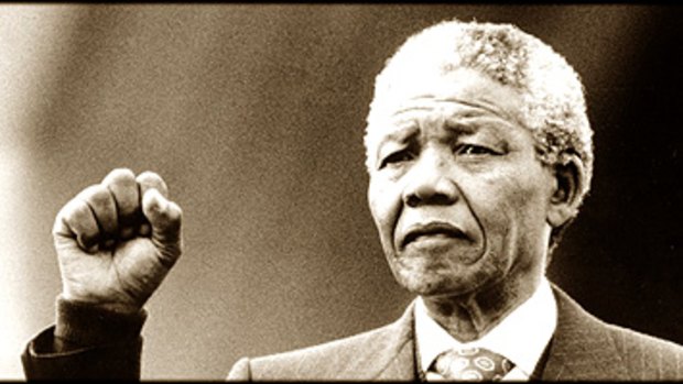Nelson Mandela raises his fist on the steps of the Sydney Opera House in 1990.