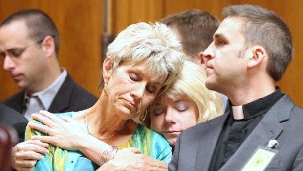 Family regards killer as a terrorist ... Jeanne Tiller hugs a family member during the sentencing of her husband's murderer.