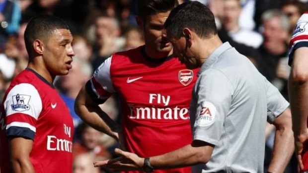It was me: Oxlade-Chamberlain tells the referee Andre Marriner that he was the guilty player.
