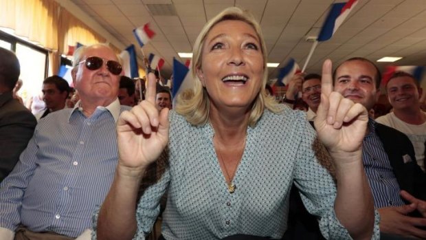 Leader of the National Front Marine Le Pen at a weekend summer university youth meeting with her father Jean Marie Le Pen (left) and Frejus Mayor David Rachline.