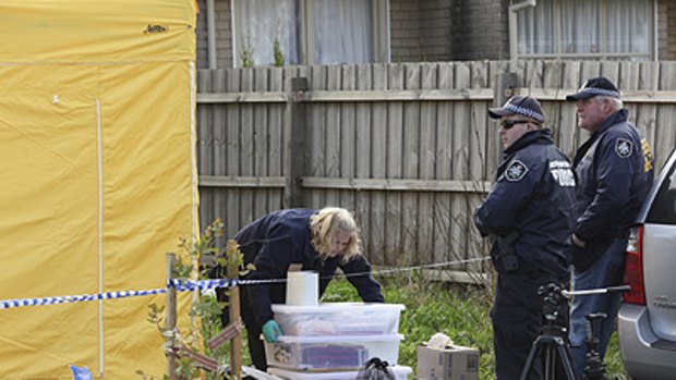 Police officers and forensic experts at a house in the suburb of Glenroy in Melbourne yesterday.