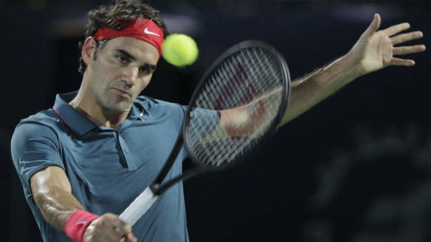 Roger Federer returns the ball to Tomas Berdych during the final of the Dubai Tennis Championships.