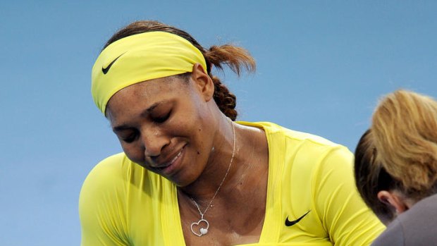 Serena Williams receives treatment after injuring her ankle.