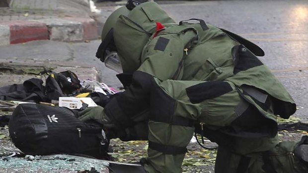 "Attempted terrorist attack" ... a bomb disposal expert examines the evidence.