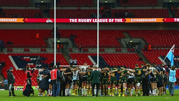 Not just the faithful: Players from Australia and Fiji gather in the centre of the field to pray after their World Cup semi-final at Wembley Stadium.