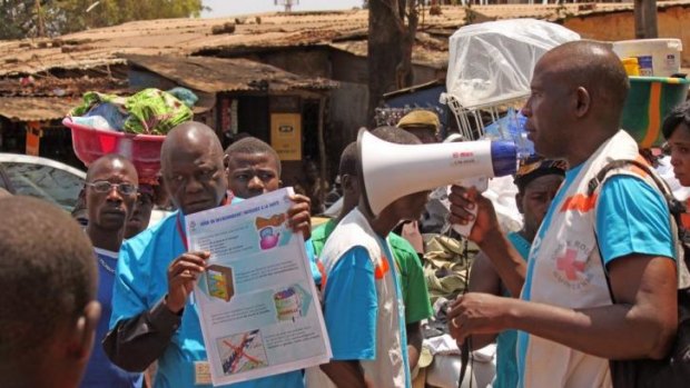 Health workers teach people about the Ebola virus and how to prevent infection in Conakry.