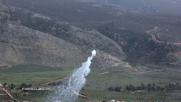 Smoke from Israeli shelling covers the Lebanese town of Al-Majidiyah (L) on the Lebanese border with Israel.