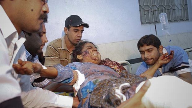 A woman injured in a suicide bomb attack at a Sufi shrine in Dera Ghazi Khan, Pakistan, is taken to a hospital in Multan.