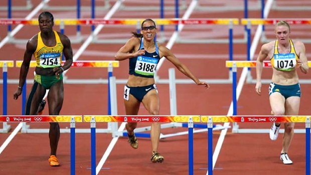 Lolo Jones strikes the penultimate hurdle at the Beijing Olympics while leading. Jones finished seventh, Sally Pearson (R) won the silver medal.