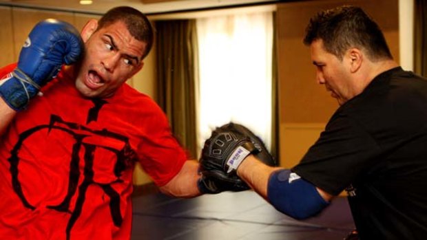 Confident . . . Cain Velasquez with trainer Javier Mendez.