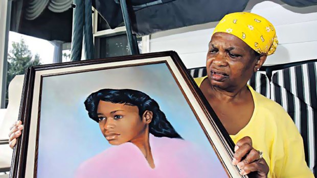 Raped and murdered ... Bessye Middleton holds a portrait of her daughter, Tryna, Romell Broom's victim.