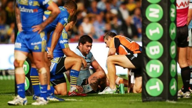 Andrew Fifita is treated for a leg injury during the loss to the Eels on Monday night.