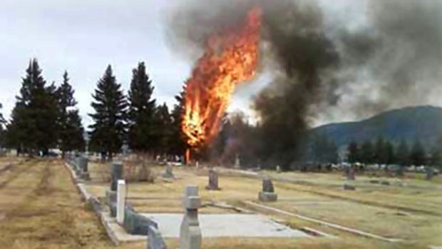 Flames and smoke rise after a passenger plane crashed on approach to an airport in Butte, Montana.