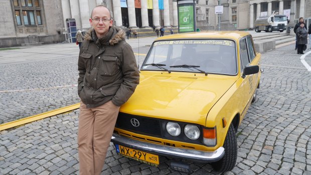 Afraid of Russia: Warsaw tour guide Marek Sidorenko with the old car that he uses for the tours.