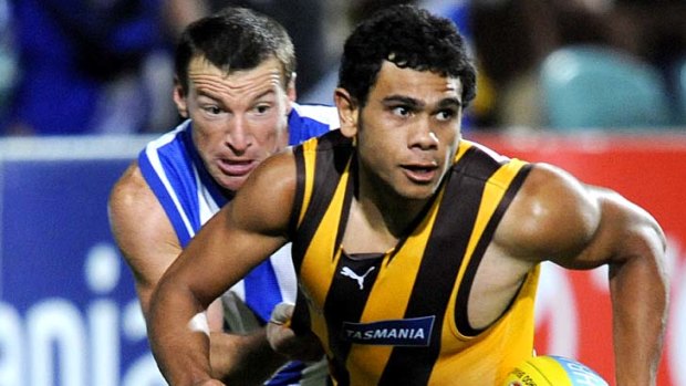 Little stars: Hawthorn's Cyril Rioli is chased by North's Brent Harvey.