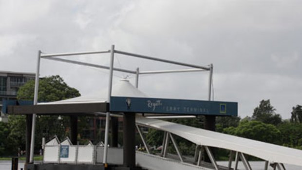 Flood waters tear at the Regatta CityCat terminal.