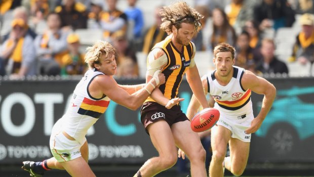 MELBOURNE, AUSTRALIA - APRIL 01: Ty Vickery of the Hawks kicks whilst being tackled Daniel Talia of the Crows during the round two AFL match between the Hawthorn Hawks and the Adelaide Crows at Melbourne Cricket Ground on April 1, 2017 in Melbourne, Australia. (Photo by Quinn Rooney/Getty Images)