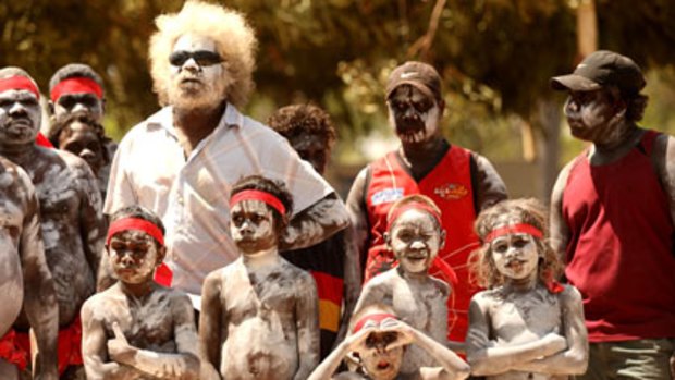 Keen to live on ancestral homelands...traditional dancers, covered from head to toe in ghostly shades of ochre, await Peter Garrett's arrival yesterday.
