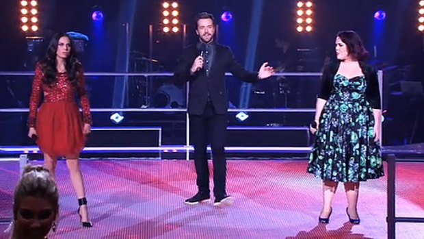 Showdown ... Host Darren McMullen, centre, with the what had to be the act of the evening; Caterina Torres, left, v Katie Reeve, right, singing Pink's <i>Try</i>.