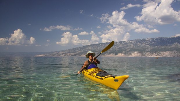 Paddling in to a beach for a swim, the Velebit mountains in the background