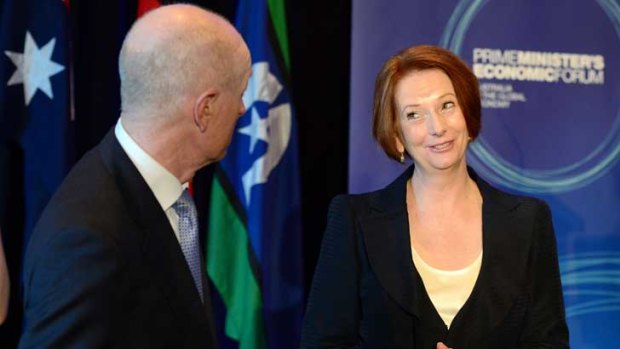 Tete-a-tete: Julia Gillard speaks with Reserve Bank governor Glenn Stevens at the economic forum in Brisbane yesterday.