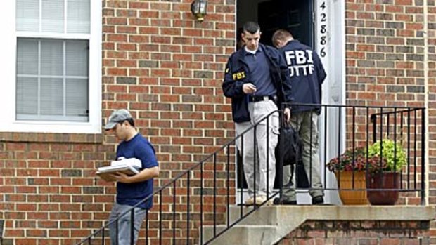 FBI Investigators leave the home of Farooque Ahmed, who has been charged with trying to help people posing as al-Qaeda operatives planning to bomb subway stations around Washington.