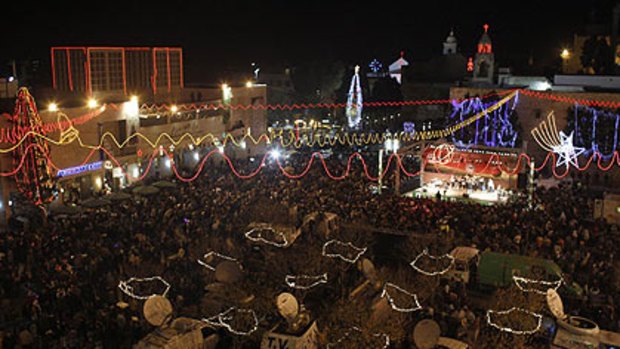 Crowds gather in Manger Square outside the Church of the Nativity, the site revered as the birthplace of Jesus, in Bethlehem on Christmas Eve.