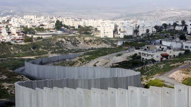 A section of the controversial Israeli barrier is seen between the Shuafat refugee camp (right), in the West Bank near Jerusalem, and Pisgat Zeev (backr), in an area Israel annexed to Jerusalem after capturing it in 1967.