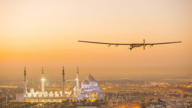 The Solar Impulse 2, a solar-powered plane, flies over Abu Dhabi during preparations for its round-the-world flight. 