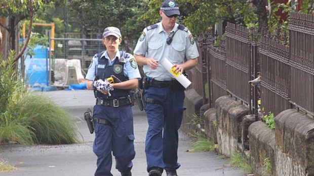 Police look for clues after a father and sone were shot in Jones Street, Pyrmont, on Sunday night.