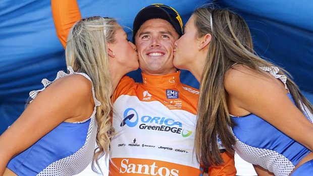 Simon Gerrans receives a kiss on the podium after being presented with the leader's jersey after stage one of the Tour Down Under in Adelaide on Tuesday.