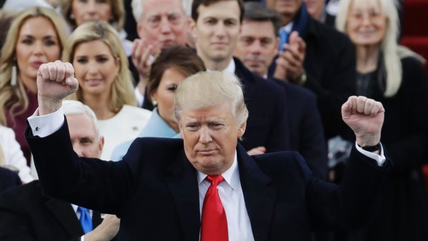 President Donald Trump pumps his fist after delivering his inaugural address.