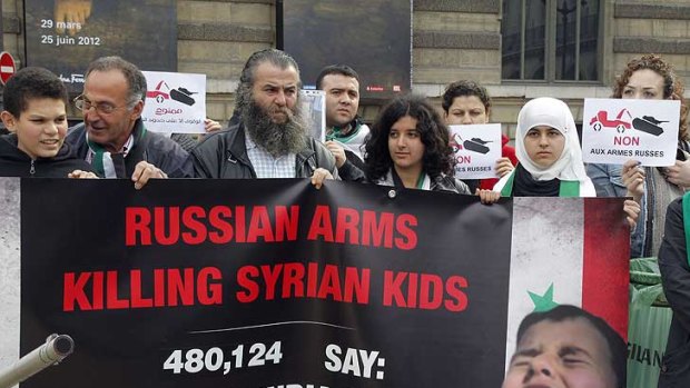 Protesters in Paris  denounce the killing of Syrian children by Russian arms.
