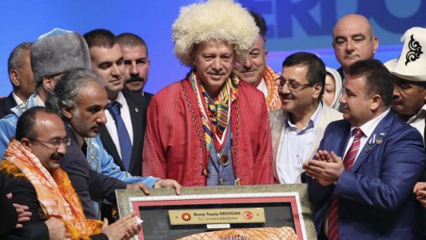 Big chief: Turkish Prime Minister and presidential candidate Recep Tayyip Erdogan is the centre of attention at a cultural reception in Ankara.