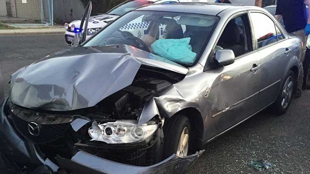 The stolen Mazda 6 was left battered after the pursuit through Perth's northern suburbs