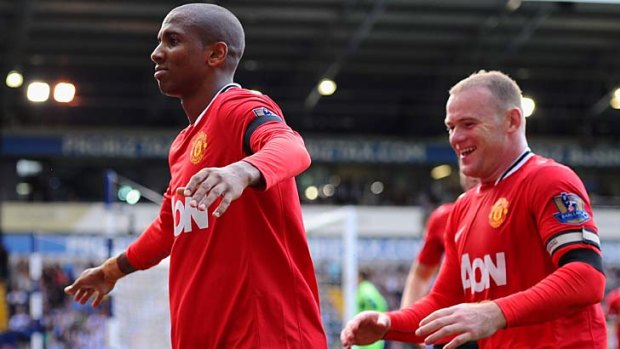 Winning start ... Ashley Young, left, celebrates with Wayne Rooney after Manchester United went 2-1 up.