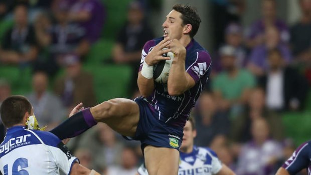 Kung Fu kid ... Billy Slater of the Storm catches a high ball and kicks David Klemmer of the Bulldogs.