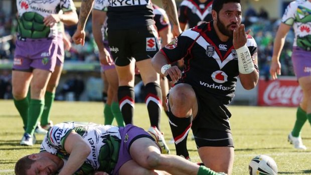 Sealed with a kiss: Warriors centre Konrad Hurrell scores against the Raiders.