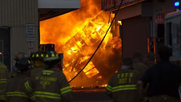 New Jersey firefighters work to control a massive fire in Seaside Park in New Jersey.