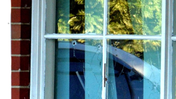 Bullet holes in the window of the house in Thomastown.