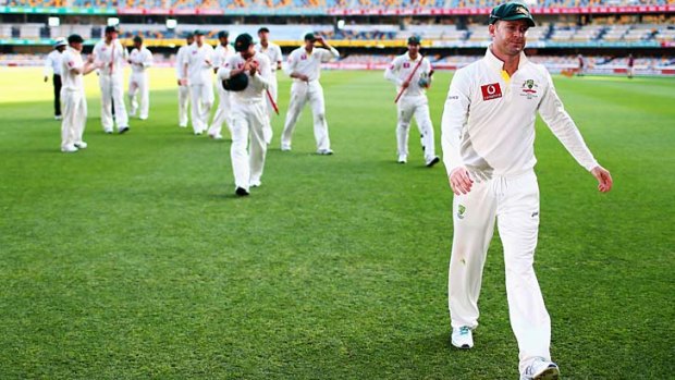 Michael Clarke leads his team from the ground after the match was drawn.