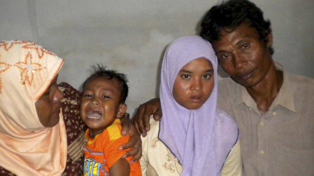 Wati with her father Yusuf, mother Yusniar and younger brother Aris at their home in Meulaboh, Aceh province, Indonesia.