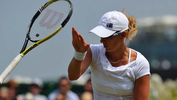 Anastasia Rodionova throws her racket during her loss to China's Li Na during the Wimbledon Tennis Championships.