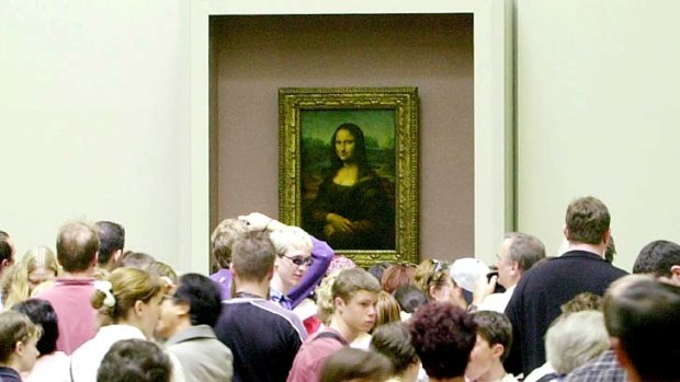 Crowded: Visitors are packed around the Mona Lisa.