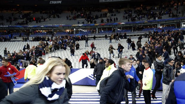 Spectators flee the Stade de France stadium after the international friendly soccer match between France and Germany.